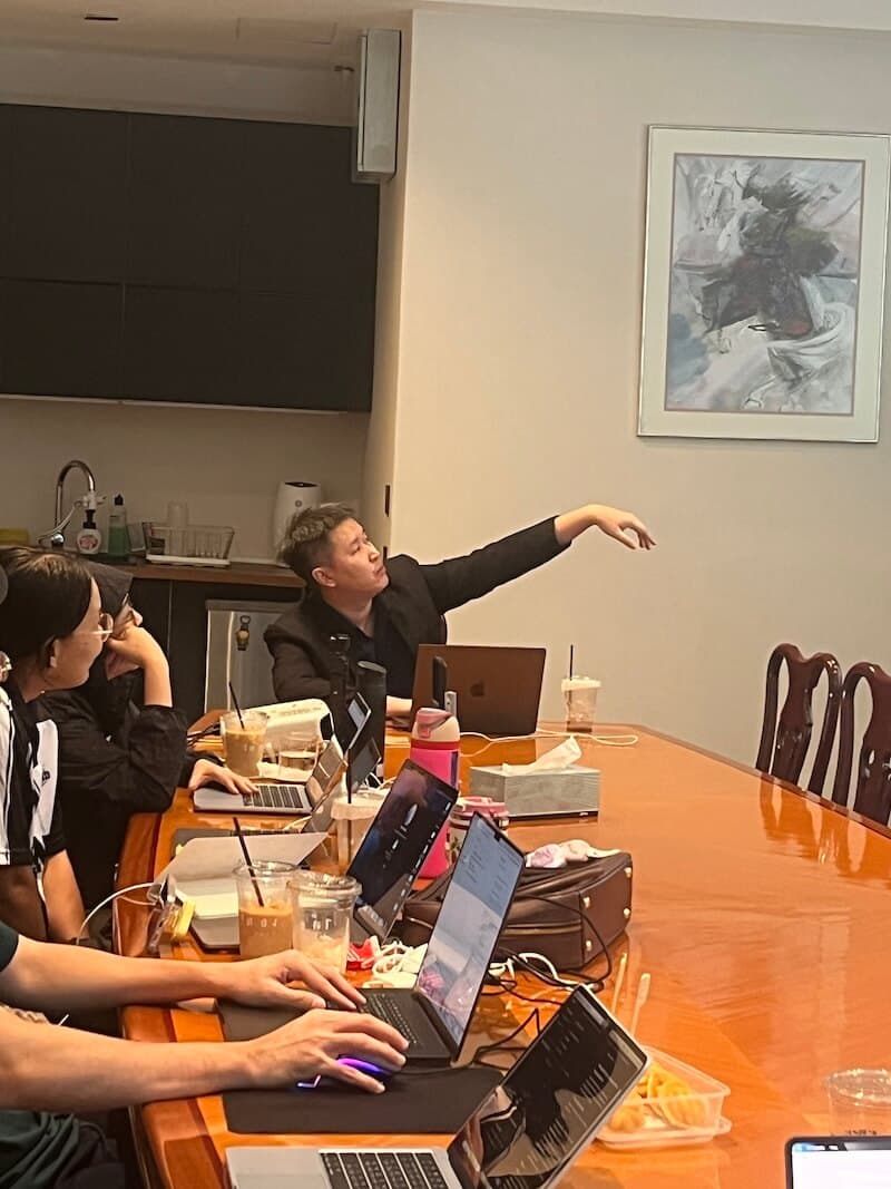 Walking the room through the projected Cursor screen while participants follow on their own laptops